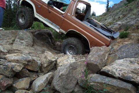 1981 Ford Bronco - This 1981 Ford Bronco tackles a challenging off-road course, demonstrating its capabilities on steep, rocky inclines.