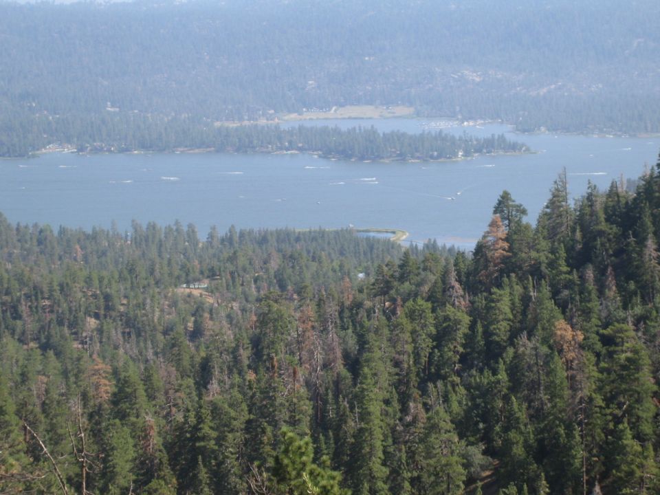 Forested mountainside overlooking a large lake with islands