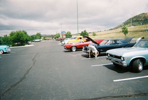 1972 Ford Ranchero - A collection of vintage automobiles are gathered in a parking lot under a cloudy sky.