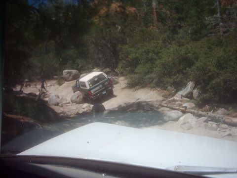 1978 Ford Bronco - This 1978 Ford Bronco is shown tackling a challenging off-road course with rocks and water.