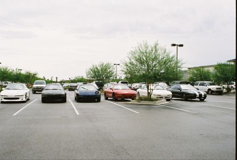 1994 Ford Probe - Multiple Ford Probes are parked in a lot under an overcast sky.