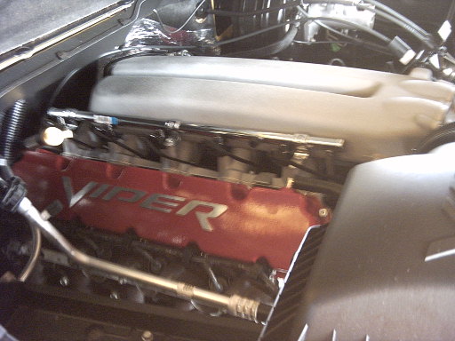 Engine bay close-up of a red Viper valve cover and intake manifold