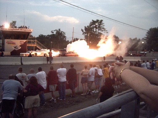 Explosion at drag strip with spectators watching