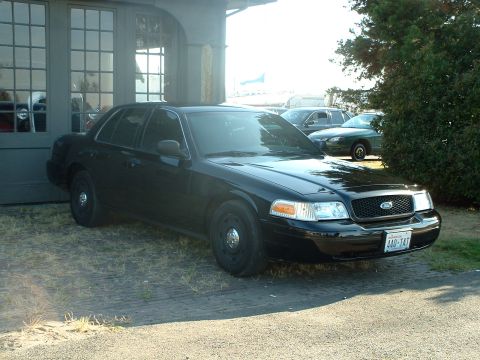 1999 Ford Crown Victoria - Black 1998 Ford Crown Victoria parked outside a building with other cars visible.