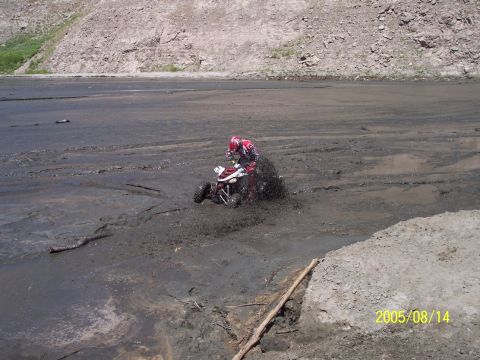 1985 Ford Bronco - A rider on a quad bike navigates through a muddy terrain, with a date stamp of 2005/08/14 visible.