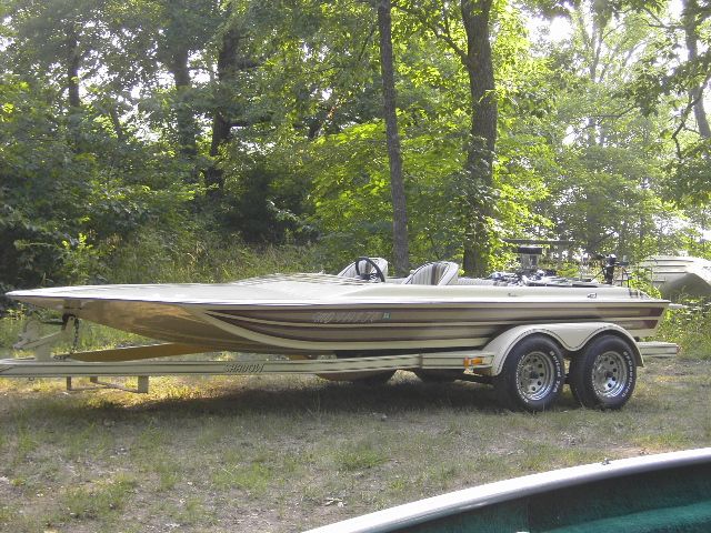 Side view of a beige and brown striped boat on a dual-axle trailer