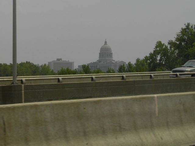 Car side view on highway with capitol building in background