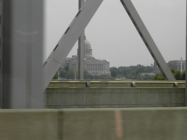 View through bridge girders of a capitol building with a dome
