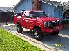 1985 Ford Bronco - This red 1985 Ford Bronco is shown from the front three-quarter angle.