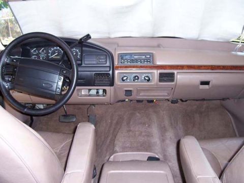 1996 Ford Bronco - The interior of a 1996 Ford Bronco features a tan dashboard and upholstery.
