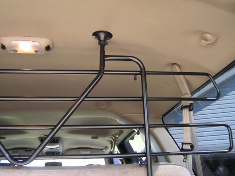 2000 Ford Excursion - Interior view of a vehicle showing a metal dog barrier mounted overhead.