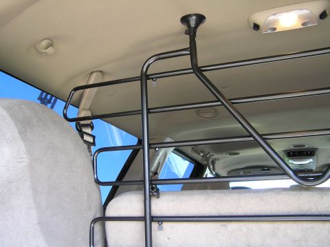 2000 Ford Excursion - A metal barrier is installed to separate the cargo area from the passenger cabin of the vehicle.