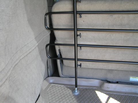 2000 Ford Excursion - Adjustable dog barrier installed behind the rear seats of a 2000 Ford Excursion.