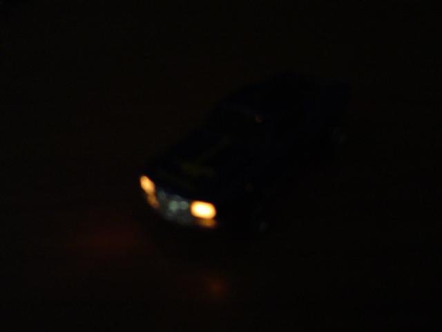 vehicle headlights glowing in the dark