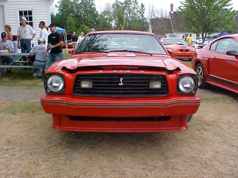 1978 Ford Mustang II - Front view of a red 1978 Ford Mustang II at an outdoor gathering.