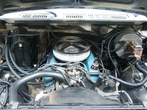 1982 Ford Bronco - The engine bay of a vehicle is shown, with various components and wiring clearly visible.