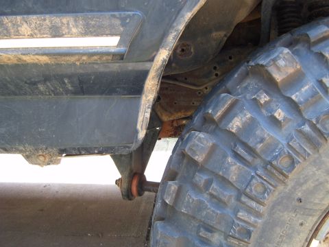 1988 Ford Bronco - Detail shot of the wheel well and fender trim, showing a large off-road tire.