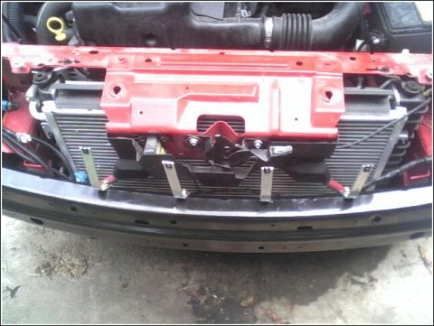 2005 Chevrolet Cavalier - Front view of a 2005 Chevrolet Cavalier's engine bay, focusing on the radiator and surrounding components.