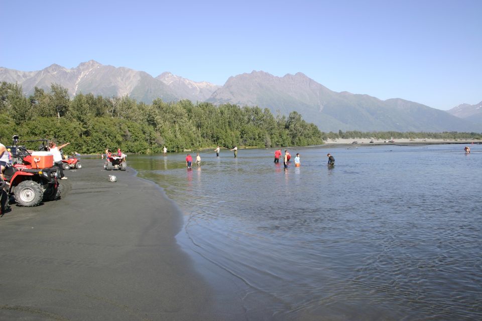 Red ATV on beach with mountains
