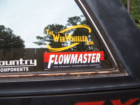 1988 Ford Bronco - Window stickers for Flowmaster and The Web Wheeler are visible on the side of a vehicle.