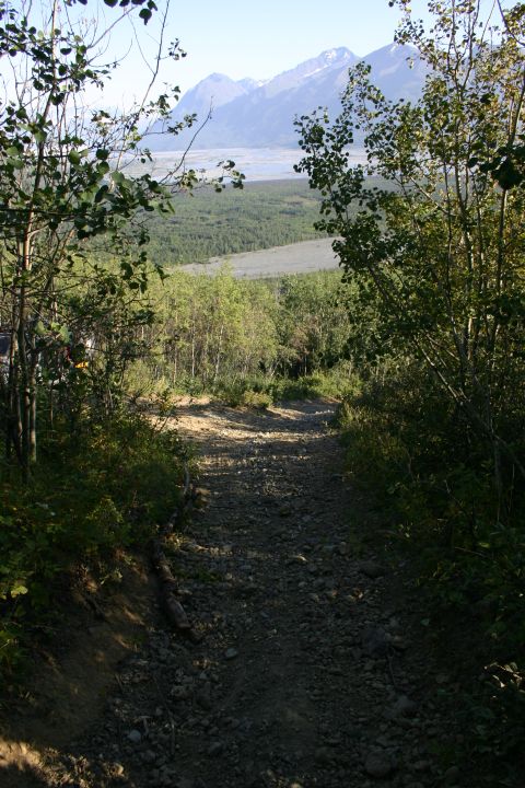 2003 Jeep TJ - A gravel path winds through trees with a valley and mountains in the background.