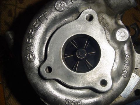 1995 Ford Mustang - This is a close-up view of a Garrett turbocharger, showing its internal turbine wheel and various markings.