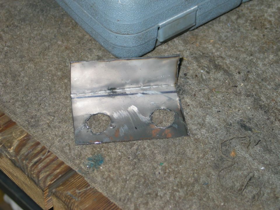 Welded metal bracket with two circular cutouts
