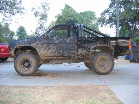 1991 Nissan Pathfinder - This Nissan pickup truck is covered in mud, suggesting it has been used off-road.