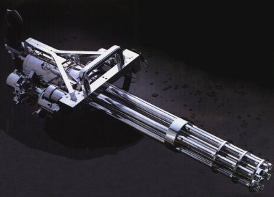 1995 Ford Bronco - Chrome minigun with multiple barrels on a dark background. Supermotors.net logo visible.