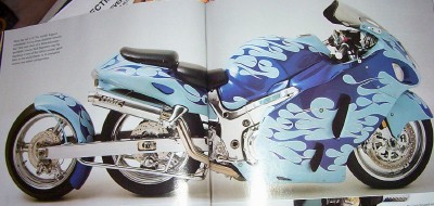 1995 Ford Bronco - A custom motorcycle with a striking flame paint job is displayed against a neutral background.