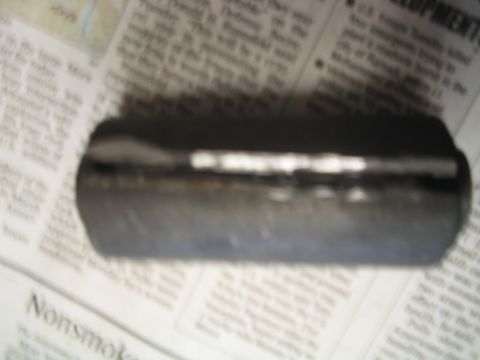 1992 Ford Bronco - A single automotive part is shown lying on top of printed newspaper articles.