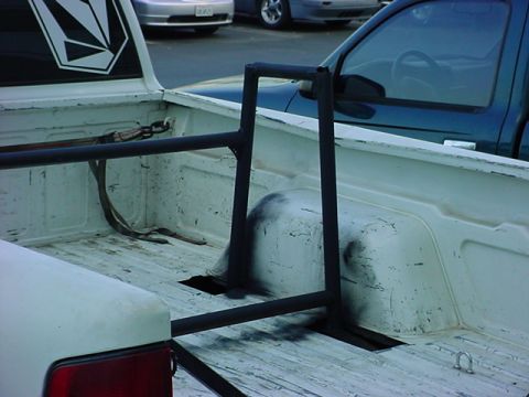 1993 Ford Bronco - Interior view of a pickup truck bed showing a roll bar and a Volcom sticker on the rear window.