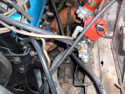 1978 Ford Bronco - Close-up view of engine bay components, including hoses, wiring, and ignition system parts.