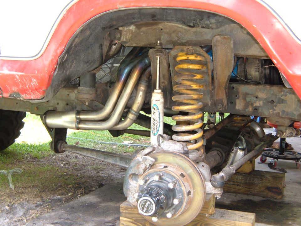 1978 Ford Bronco front suspension with custom headers and yellow coil springs