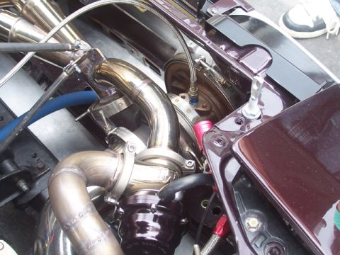 1990 Ford Probe - Custom turbocharger setup with polished exhaust piping and wastegate visible.