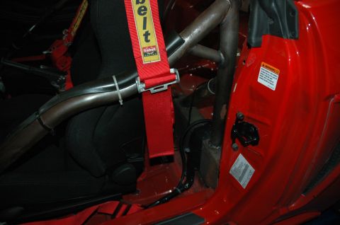 2000 Ford Mustang - Interior view of a racing seat with a Sabelt harness and roll cage.