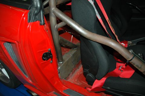 2000 Ford Mustang - Interior view of a car with a custom roll cage and racing seat installed.