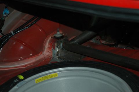 2000 Ford Mustang - Close-up view of a car's trunk interior, showing a roll cage and spare tire.