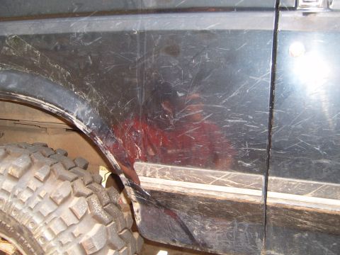 1988 Ford Bronco - Close-up of the fender trim and a large off-road tire on a 1988 Ford Bronco.