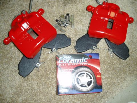1993 Ford Taurus - Red brake calipers and a box of Morse ceramic disc brake pads are laid out on a carpeted surface.