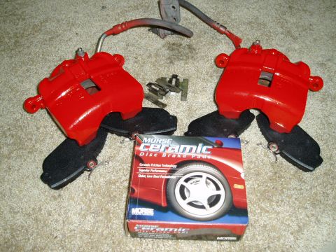 1993 Ford Taurus - New brake calipers and pads are laid out on the carpet, ready for installation.