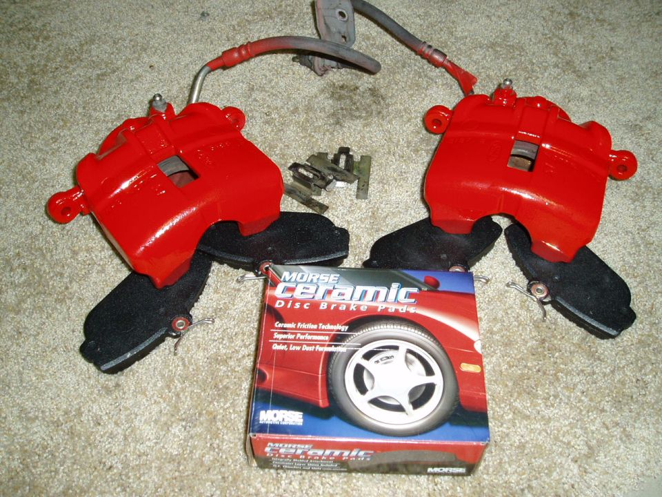 pair of red brake calipers, hardware, and a box of Morse Ceramic disc brake pads