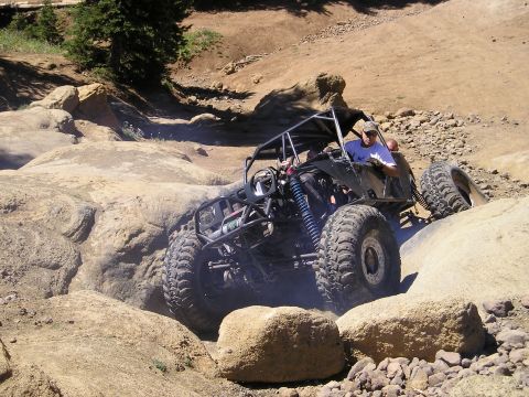 1989 Ford Bronco - A custom off-road buggy tackles a challenging rocky trail.