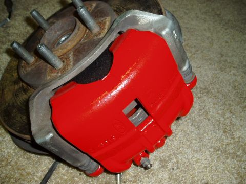 1993 Ford Taurus - A red brake caliper and rotor assembly is shown, likely a replacement part.