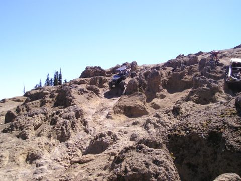 1989 Ford Bronco - Two off-road vehicles tackle a challenging rocky incline during an event in August 2005.