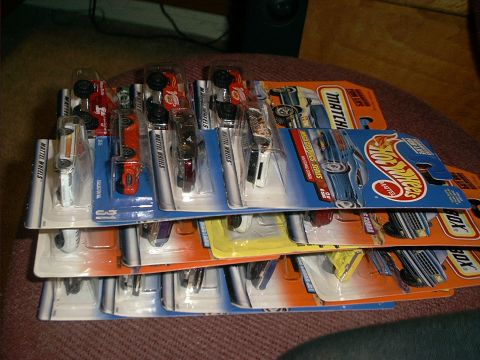 1990 Ford Bronco - Multiple toy cars from various brands are displayed in their original packaging.