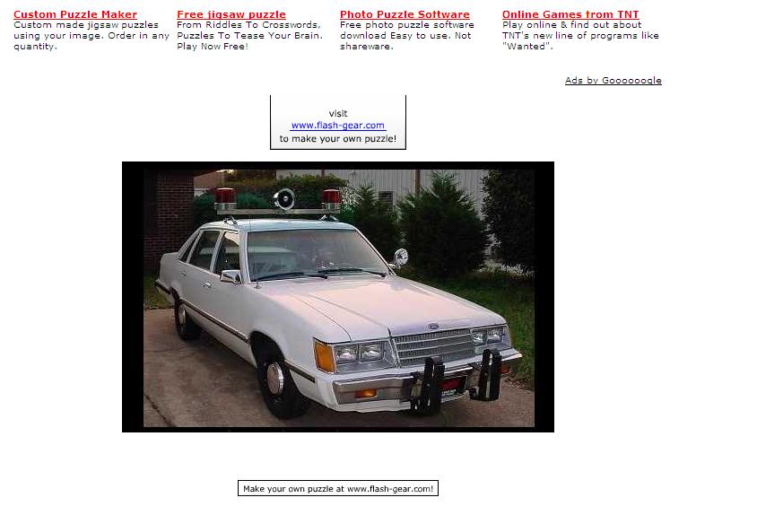 White police car with light bar, 1980s body style