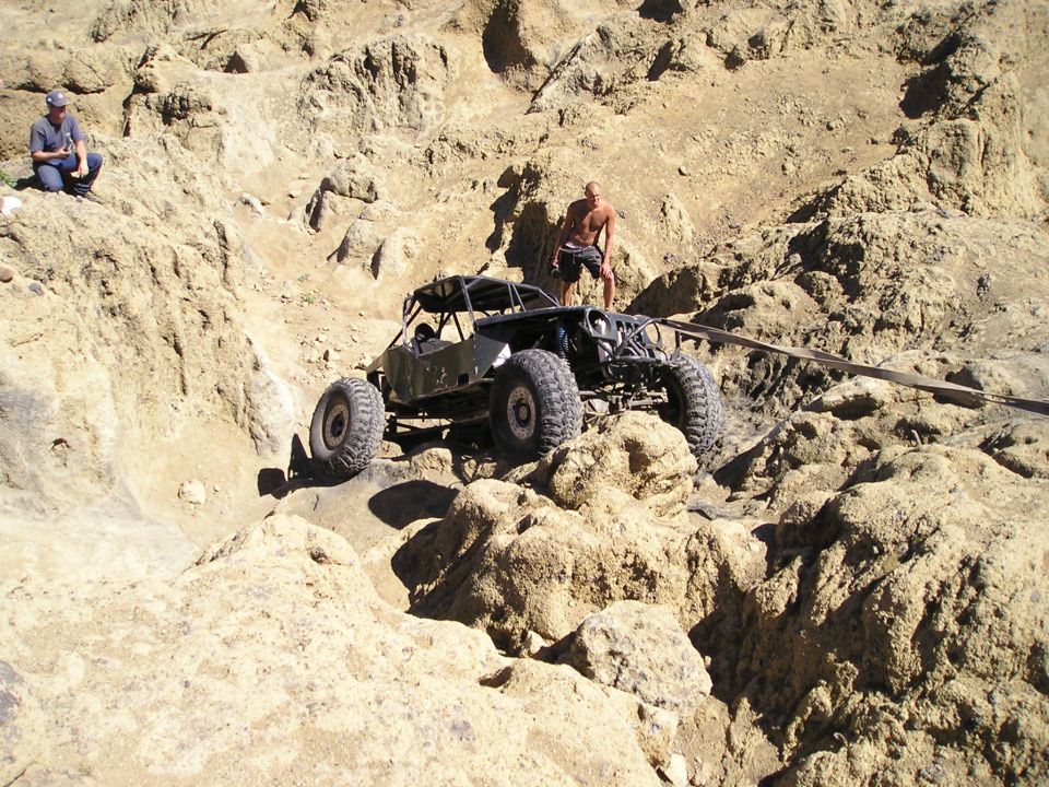 Off-road buggy climbing rocky terrain