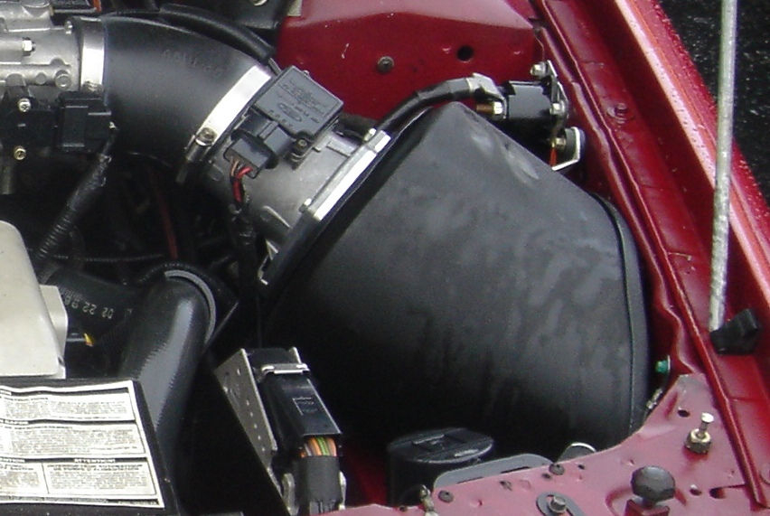 Engine bay intake with black airbox, rubber tube and Ford mass air flow sensor