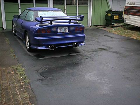 1993 Ford Probe - The rear view of a blue 1993 Ford Probe shows its distinctive spoiler and dual exhaust tips.